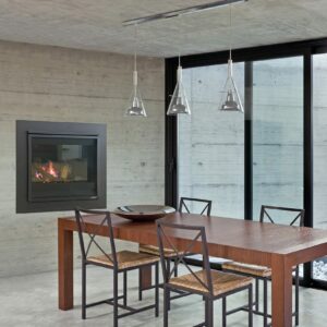 Long narrow wooden table with four chairs next to windows